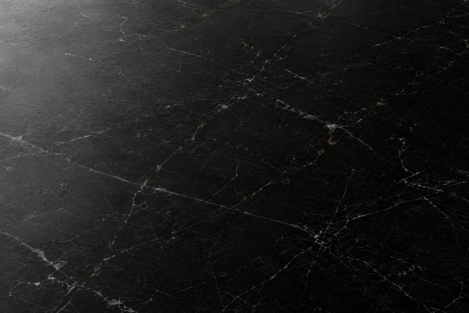 Marquina preto com acabamento semi-polido: brilho difuso, sem reflexo nítido, o preto um tom mais aberto.